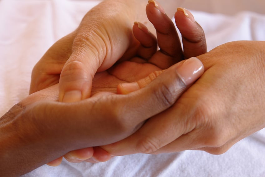 Hand reflexology being performed