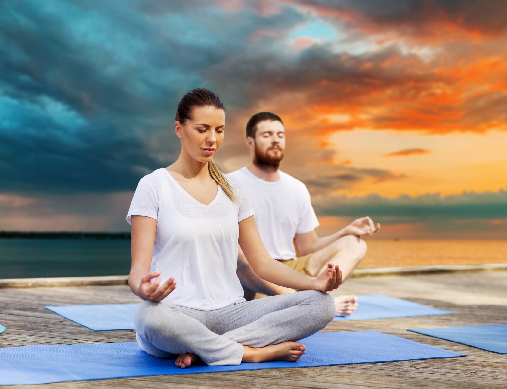 Couple Meditating in Yoga Lotus Pose Outdoors